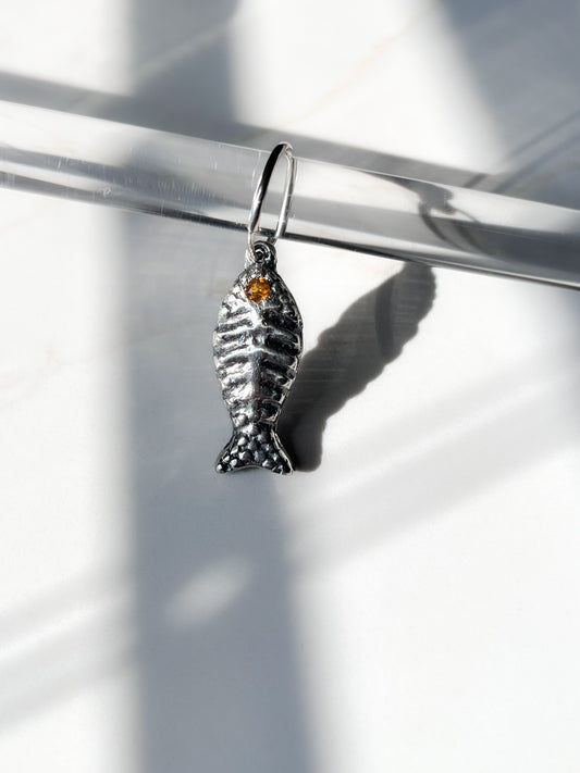 Bone fish charm with orange tourmaline gemstone on endless hoop