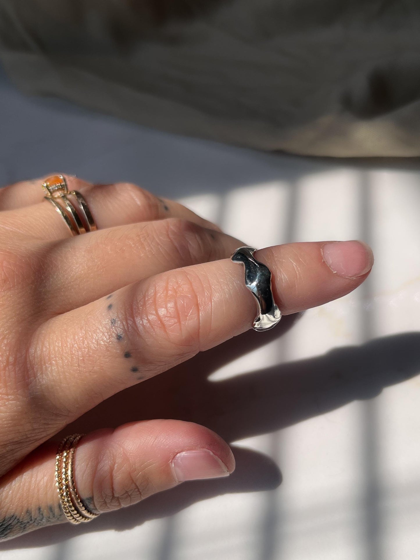 Silver wavy band on hand